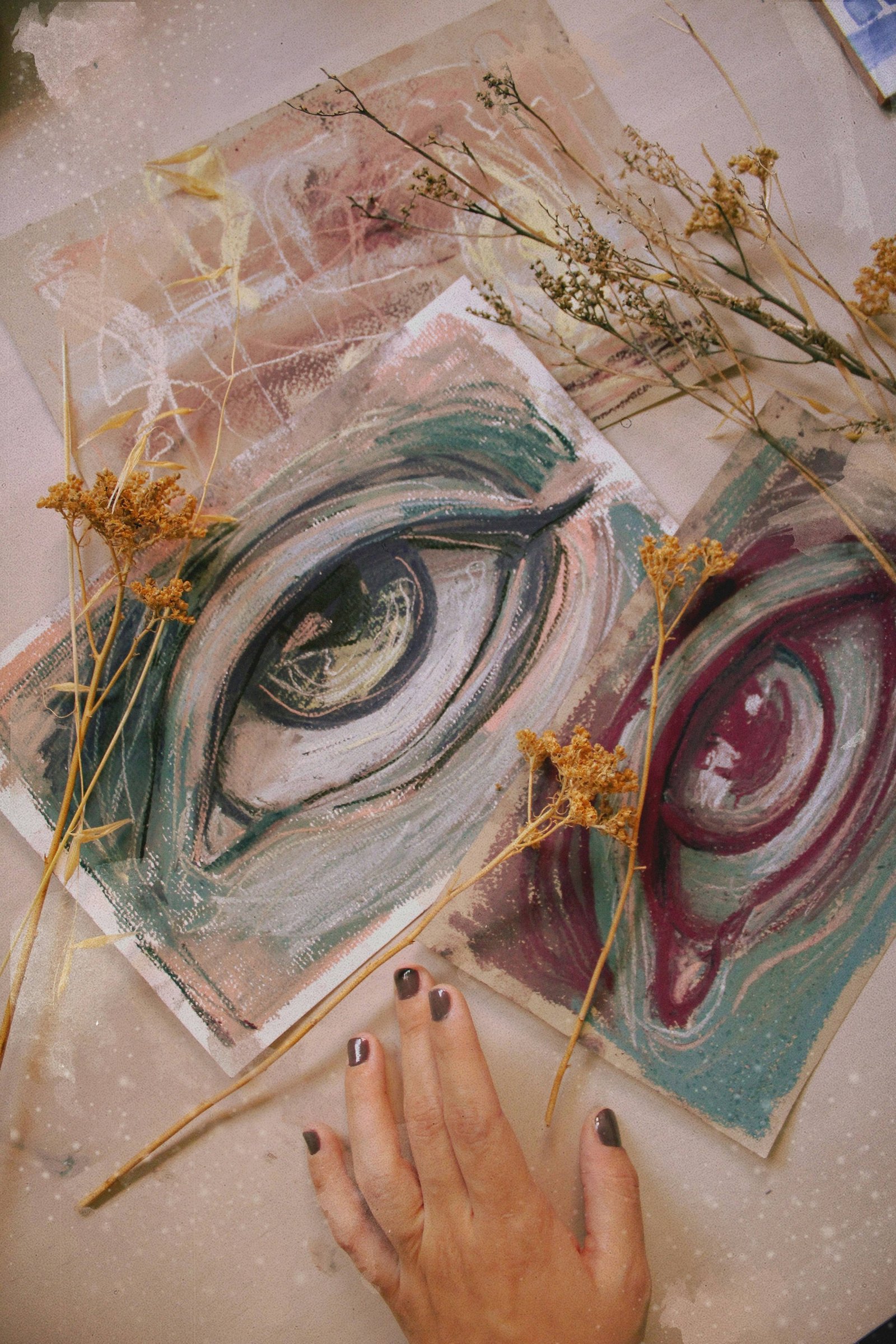 Eye artwork drawn on paper with dried flowers