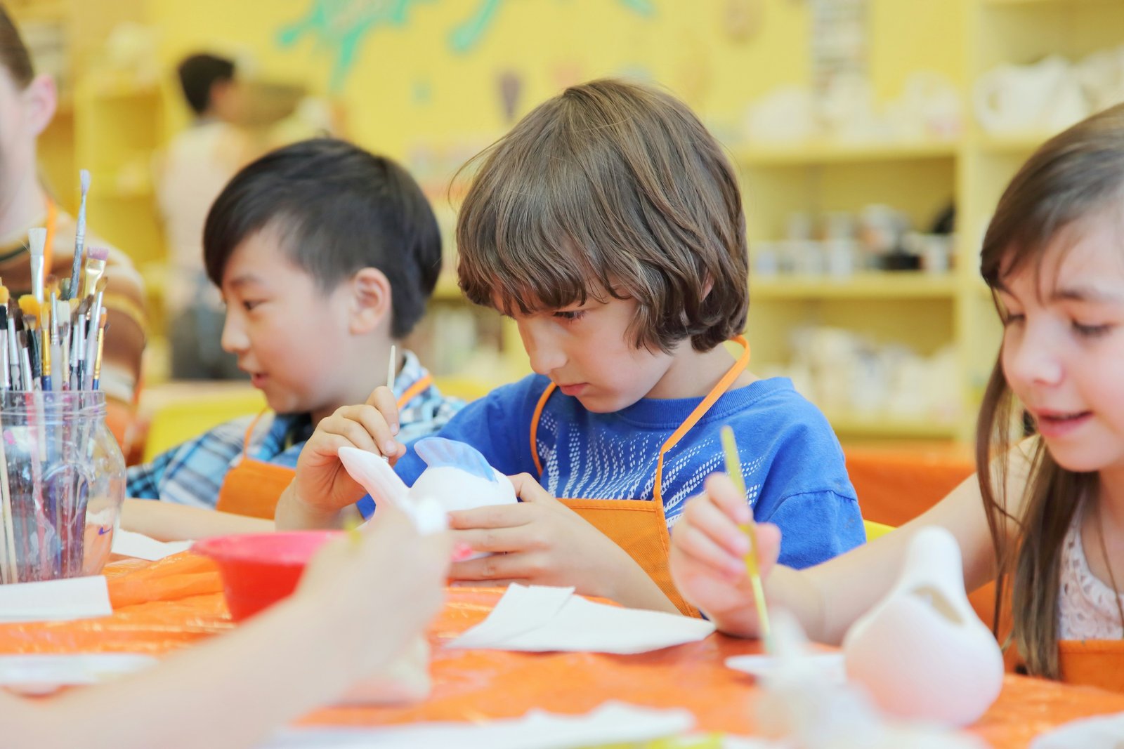Boy painting with a watercolour set
